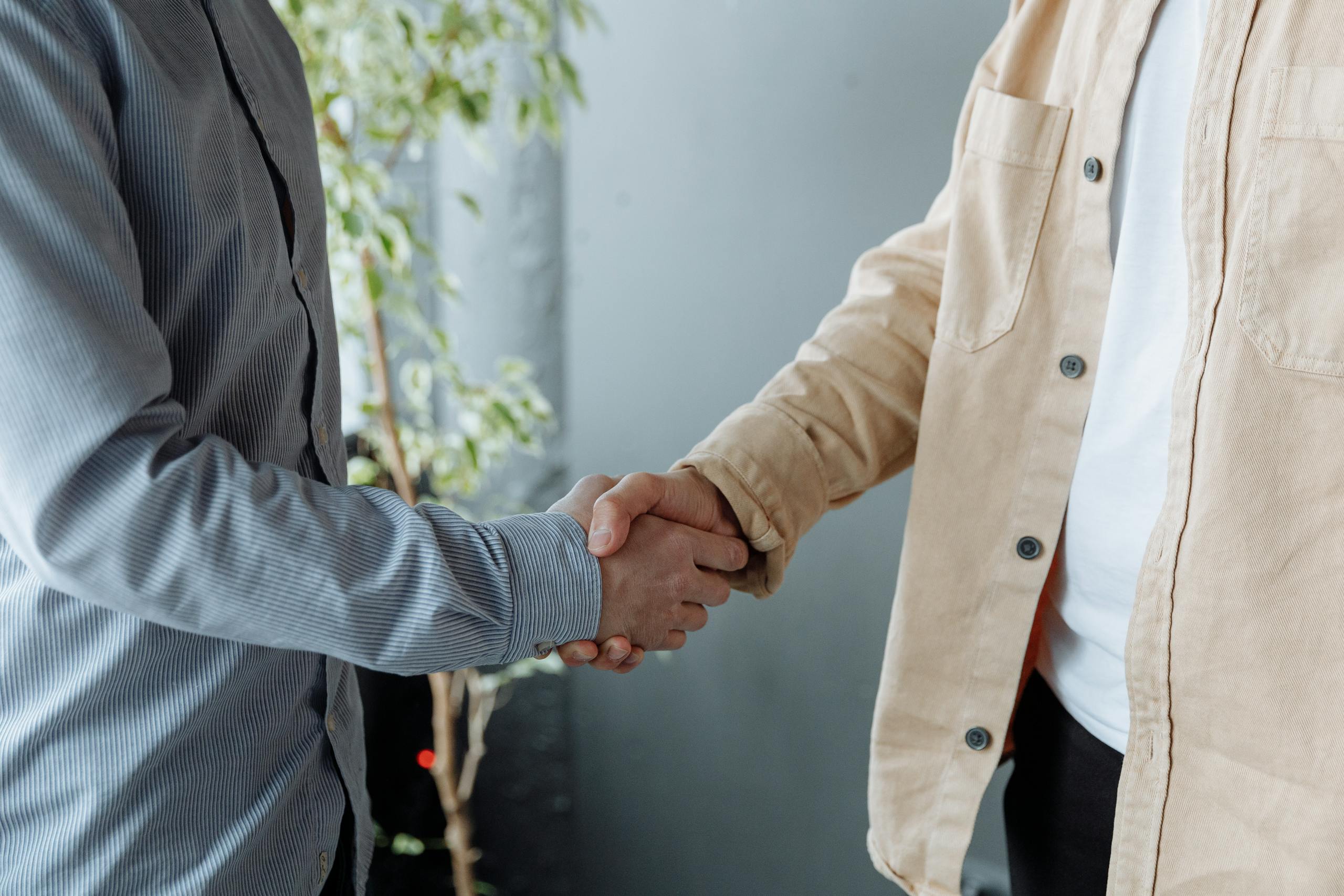 Close-up of a handshake symbolizing a fractional HR partnership agreement.