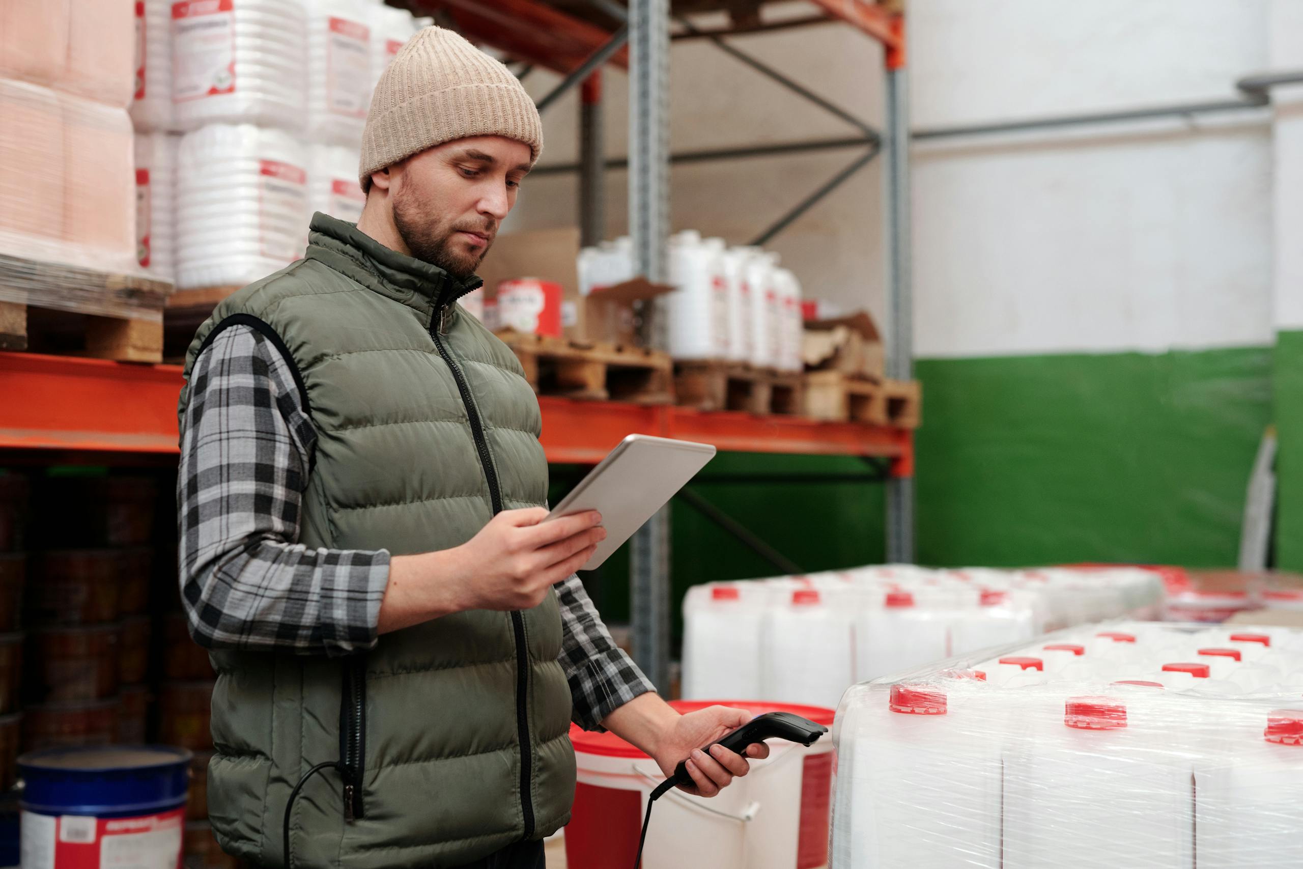 MVR Monitoring Checks | Continuous Driver Compliance 1 A worker managing inventory with a tablet in a warehouse