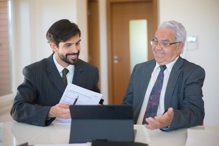 Two businessmen discussing a real estate deal in a modern office setting.