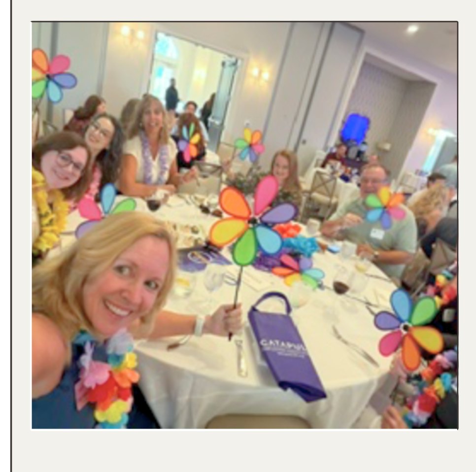 Catapult team at their table holding flower pinwheels during the 2026 Best Employers Gala at Elon University.