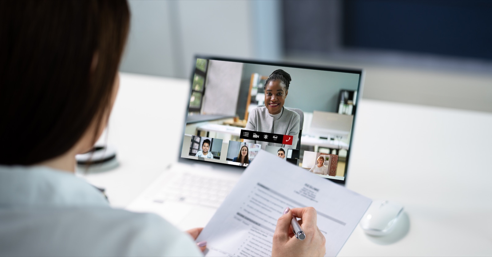 HR professional reviewing a candidate resume during a live virtual meeting
