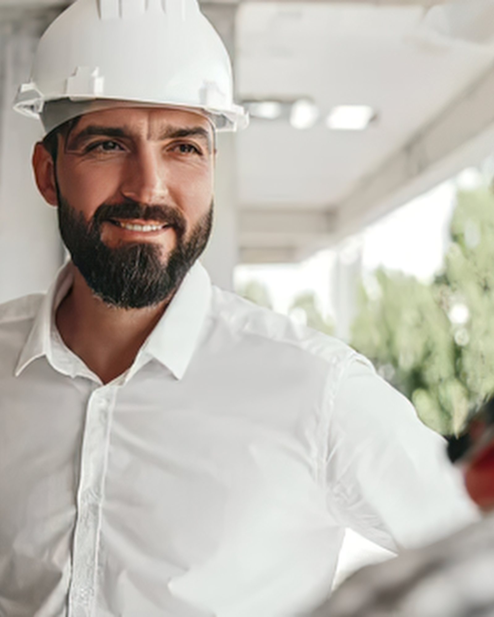 A site manager in a hard hat on a construction project