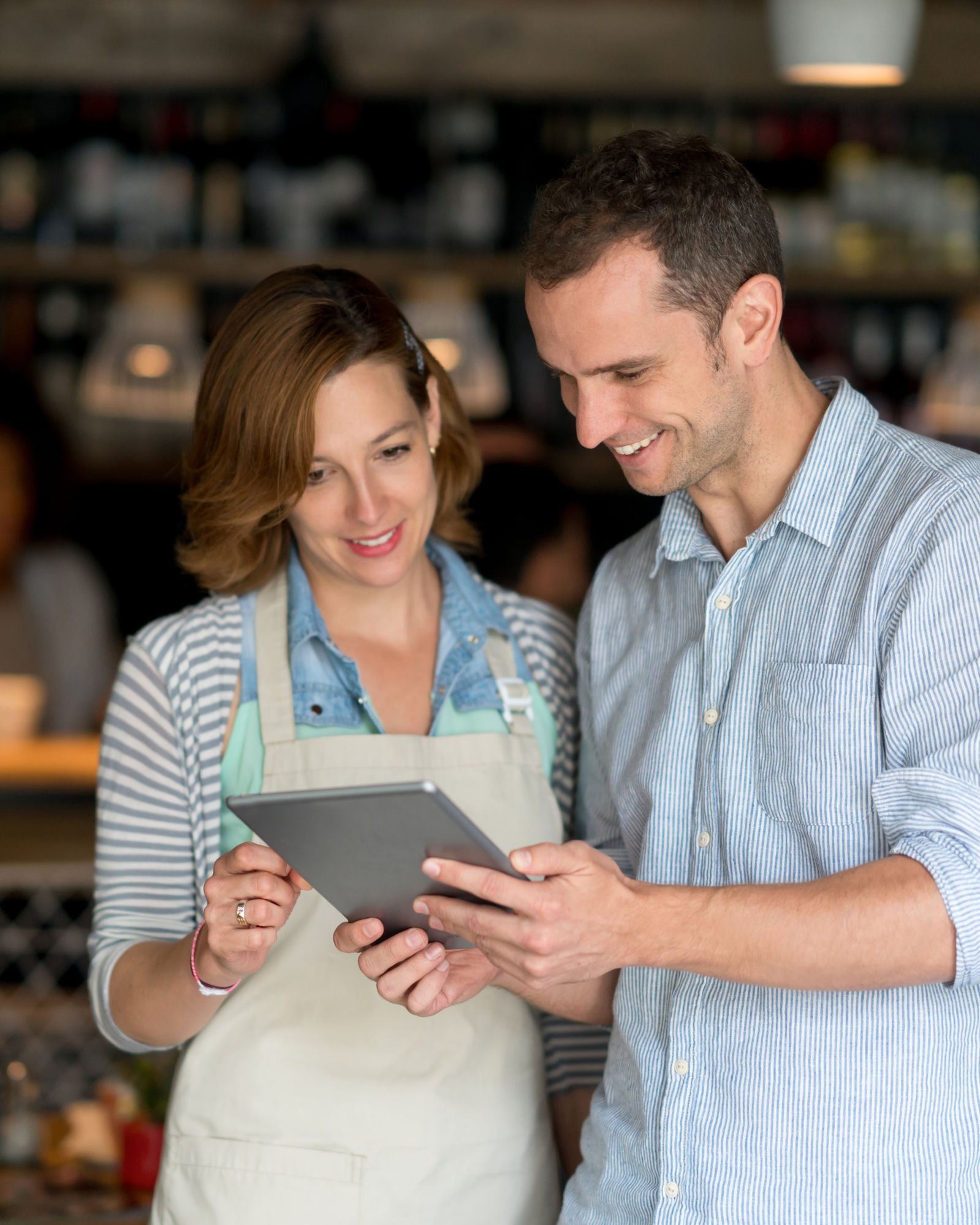 On-Demand HR Services for NC & SC Employers 1 Two small business owners reviewing options on a tablet