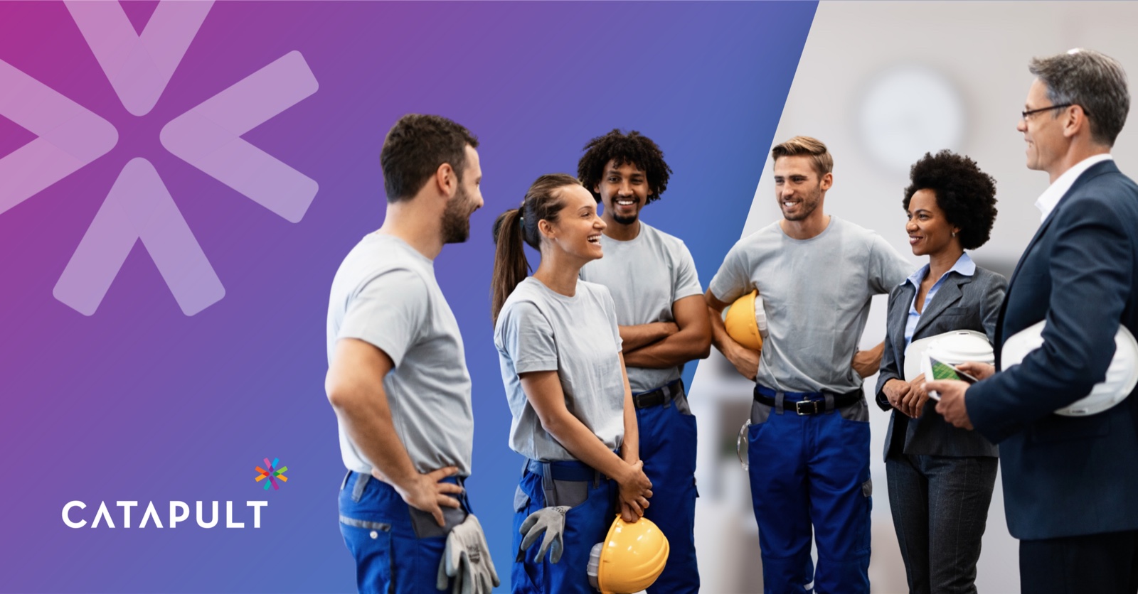A manager and a supervisor talking with a team of frontline employees holding hard hats