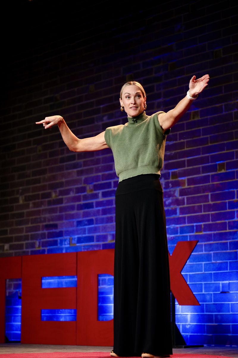 Page Fehling speaking on a TEDx stage