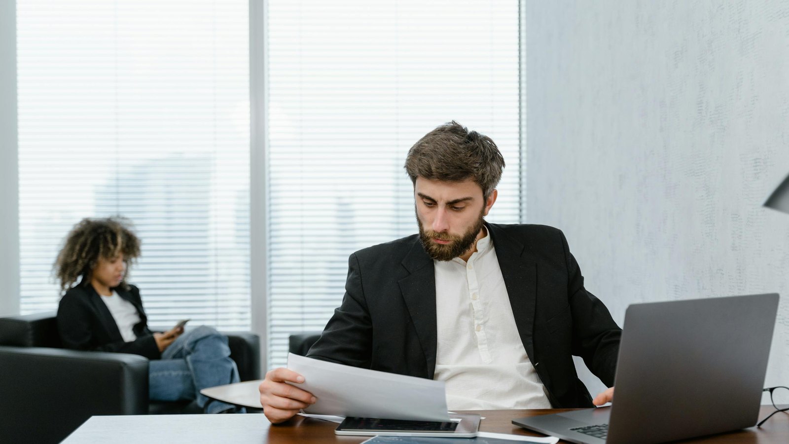 A manager reviews a training results report at his desk