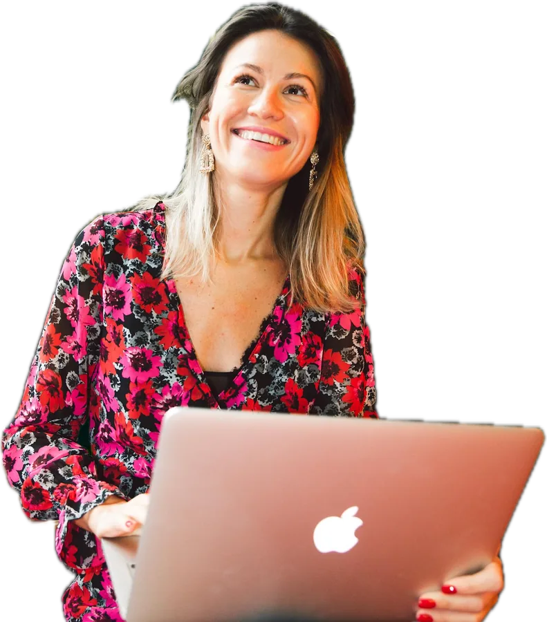 A professional smiling while taking a live online class on her laptop